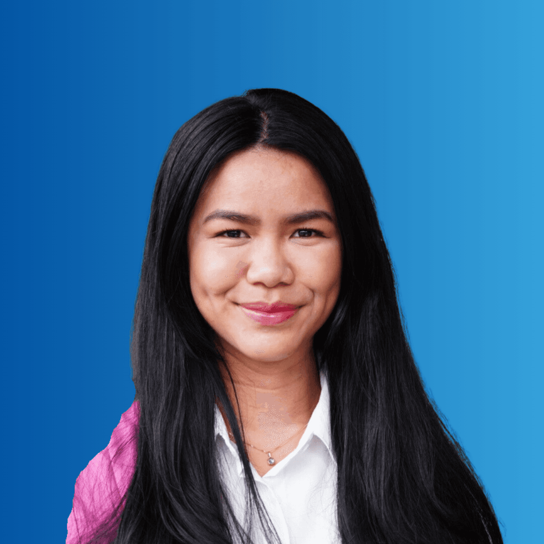 A woman smiling at the camera on a blue background